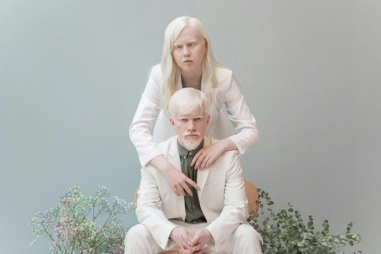 a man and a woman sitting next to each other, an album cover, by Matija Jama, renaissance, albino white pale skin, nordic pastel colors, family photo, light gray long hair