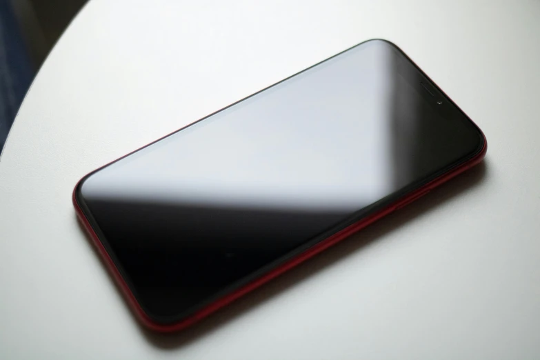 a close up of a cell phone on a table, by Robbie Trevino, pexels, gradient red to black, modern minimalist f 2 0 clean, portrait n - 9, rounded corners