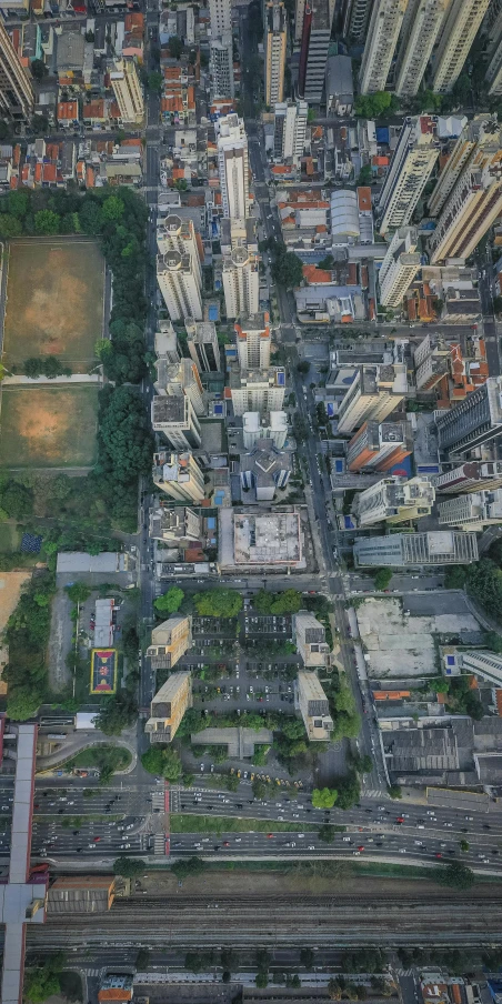 an aerial view of a city with lots of tall buildings, by Joze Ciuha, pexels contest winner, photorealism, são paulo, google earth, singapore ( 2 0 1 8 ), parks and public space