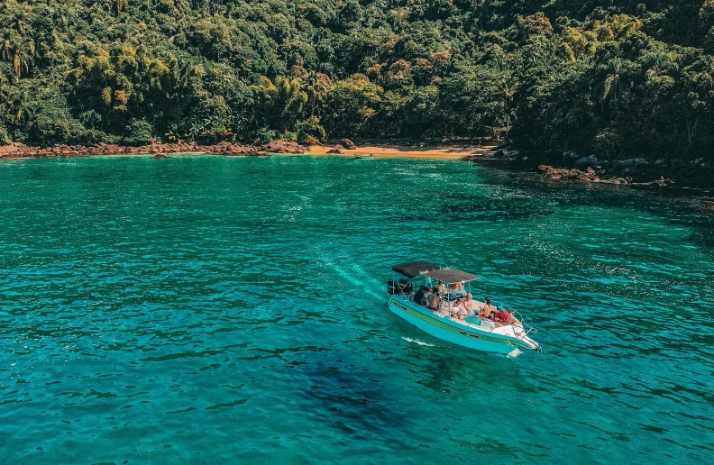 a boat in the middle of a large body of water, abel tasman, people swimming, instagram picture, profile image