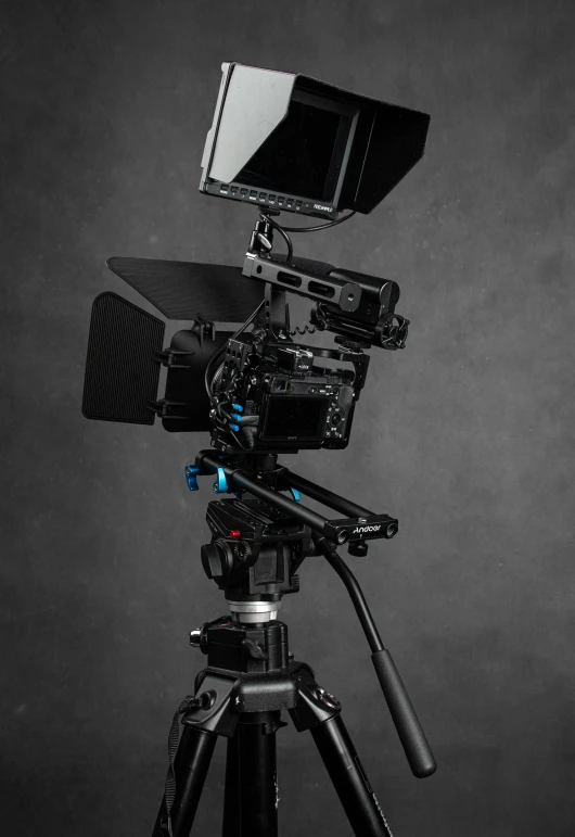 a black and white photo of a camera on a tripod, a 3D render, featured on zbrush central, blue color grading, holding it out to the camera, red cinema camera, dark setup