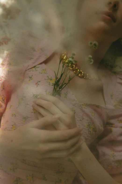 a woman in a pink dress holding a flower, inspired by Elsa Bleda, gold flaked flowers, live-action archival footage, fairycore, ignant