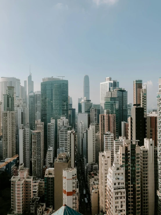 a view of a city from the top of a building, by Patrick Ching, tall minimalist skyscrapers, low quality photo