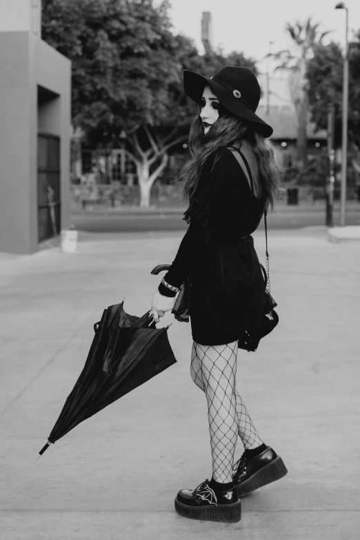 a black and white photo of a woman with an umbrella, inspired by Louis Grell, tumblr, wearing a punk outfit, 15081959 21121991 01012000 4k, goth girl aesthetic, wearing fishnets