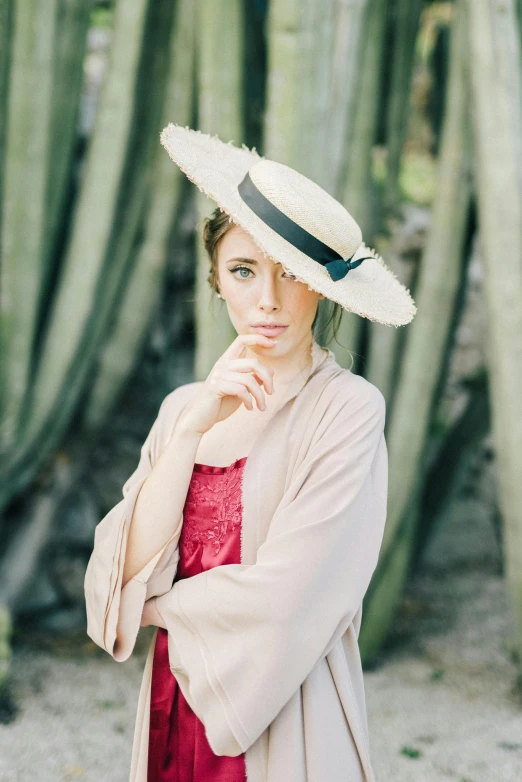 a woman in a red dress and a white hat, a portrait, by Lucette Barker, unsplash, lush surroundings, sydney sweeney, wearing cylinder hat, photo of a model