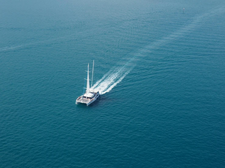 a boat in the middle of a large body of water, a high angle shot