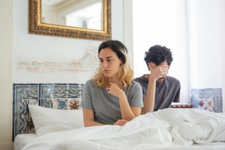 a man and a woman sitting on a bed, by Julia Pishtar, pexels, unhappy, wearing a grey robe, slim, thumbnail