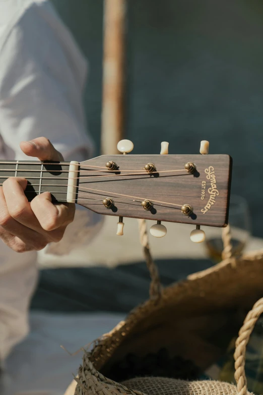 a close up of a person playing a guitar, on the ocean, holding guitars