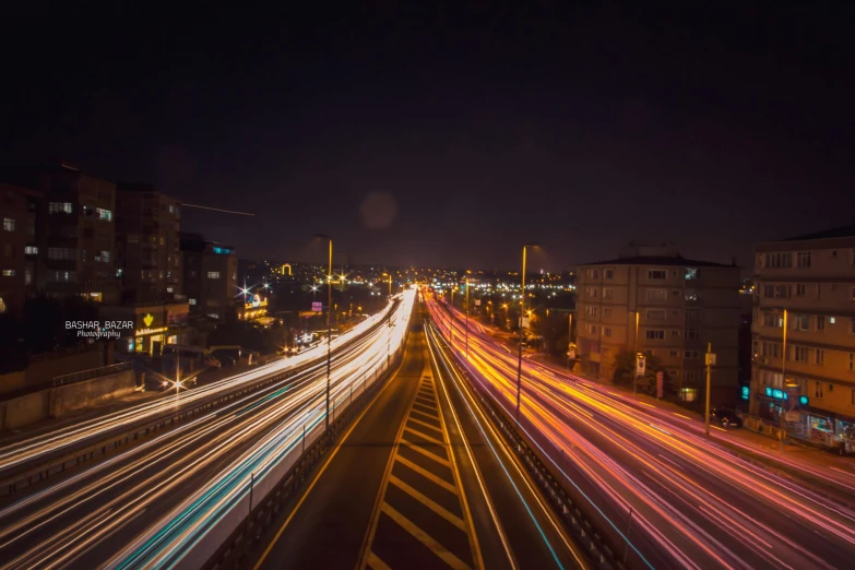 a city street filled with lots of traffic at night, an album cover, pexels contest winner, tehran, speed lines, long distance photo, computer wallpaper