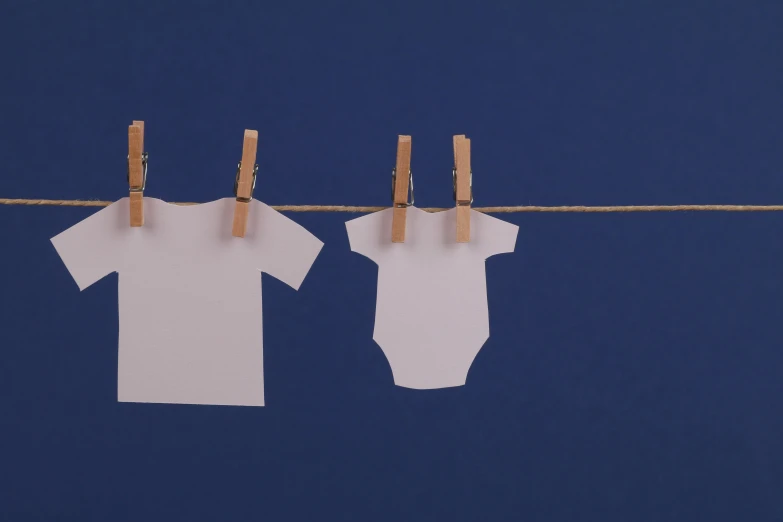 clothes hanging on a clothes line with clothes pins, inspired by Anne Geddes, unsplash, conceptual art, blue backdrop, diaper-shaped, white shirts, blue print