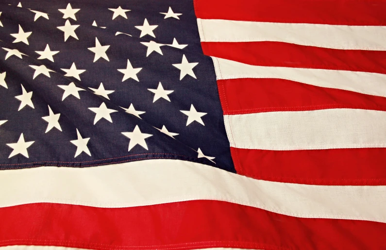 a close up of an american flag on a bed, profile image