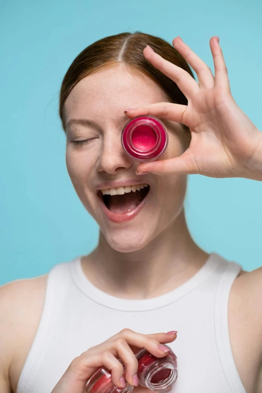 a close up of a person holding a bottle of lipstick, pexels contest winner, pop art, spherical lens, laughing, clutch yo - yo, adafruit