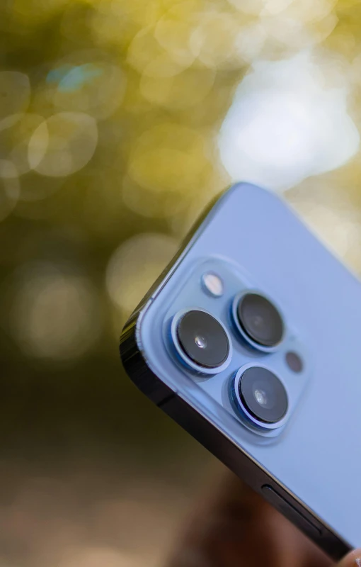 a close up of a person holding a cell phone, pexels, photorealism, shot on iphone 1 3 pro, blue colored, it has six thrusters in the back, high resolution photo