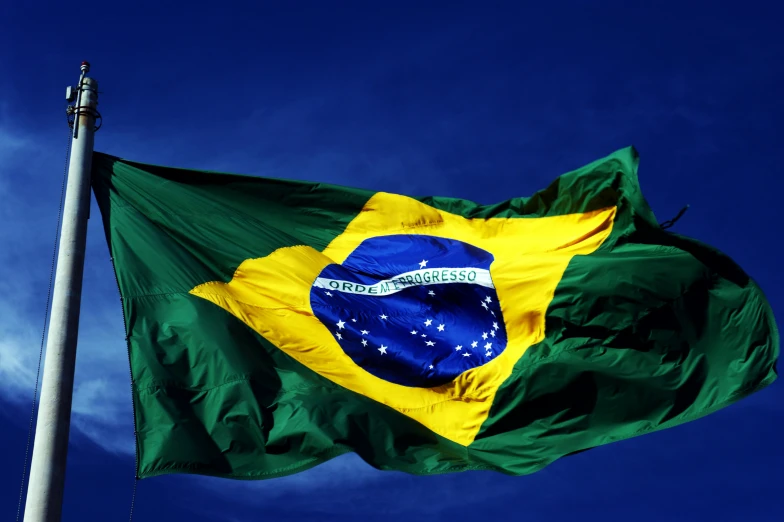 the flag of brazil flies high in the blue sky, an album cover, inspired by Samuel Silva, pexels contest winner, square, steam workshop, formula 1, high resolution image