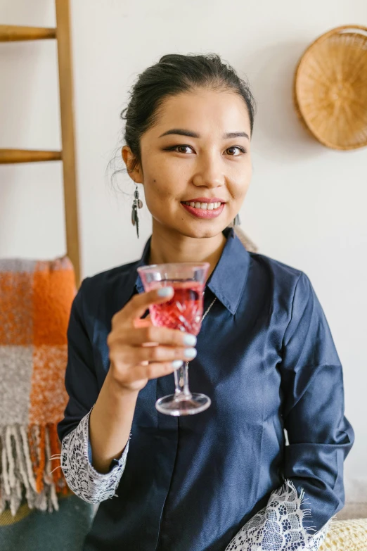 a woman sitting on a couch holding a wine glass, a portrait, inspired by Ruth Jên, trending on unsplash, young asian woman, people drink cocktails, standing, portrait n - 9