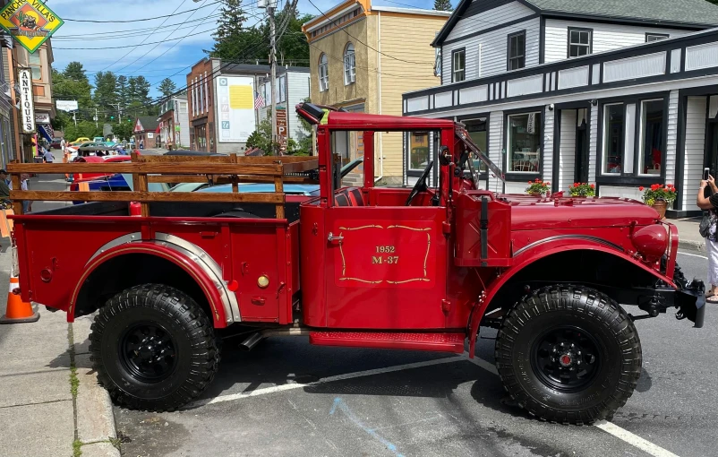 a red truck parked on the side of the road, restored, fire theme, square, taken in the early 2020s