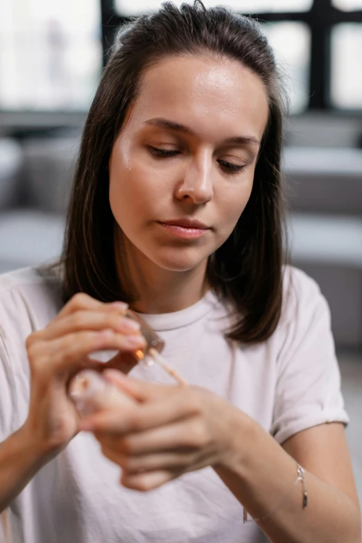 a woman sitting at a table with a cigarette in her hand, pexels contest winner, making a potion, teenage girl, acupuncture treatment, profile image