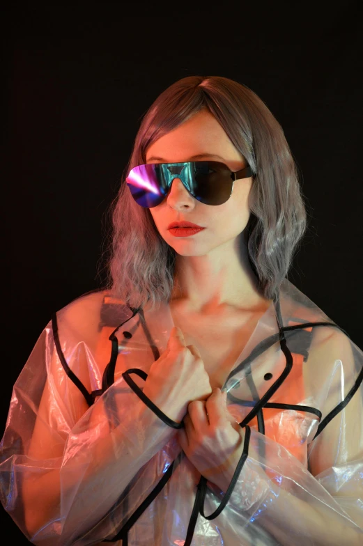 a woman wearing a plastic jacket and sunglasses, inspired by Gao Cen, unsplash, futurism, rgb ethereal lighting, amouranth, alternate album cover, taken in the late 2010s