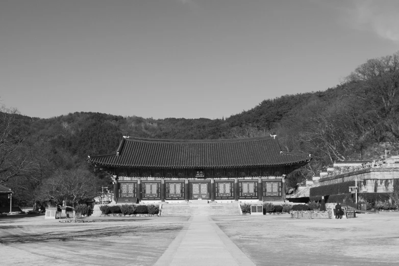 a black and white photo of a building, inspired by Kim Hong-do, pexels contest winner, korean traditional palace, square, brown, stadium setting