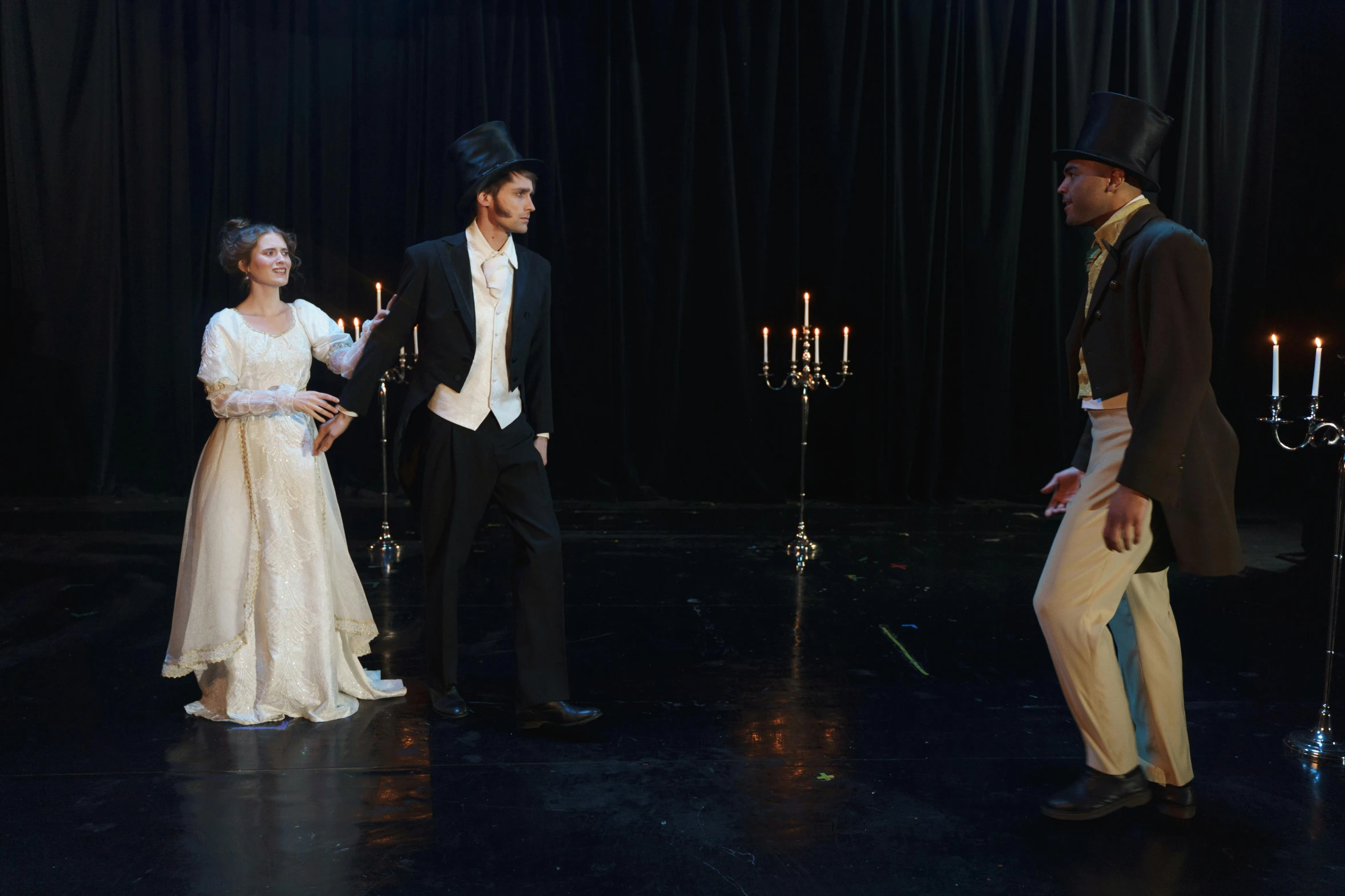 a couple of people standing next to each other on a stage, inspired by William Quiller Orchardson, unsplash, renaissance, wearing a top hat, 3 actors on stage, in a room full of candles, ( ( theatrical ) )