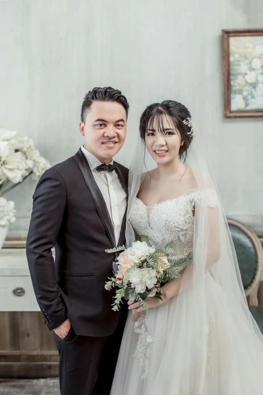 a man in a tuxedo standing next to a woman in a wedding dress, inspired by Ruth Jên, lovingly looking at camera, vietnam, indoor setting, profile image