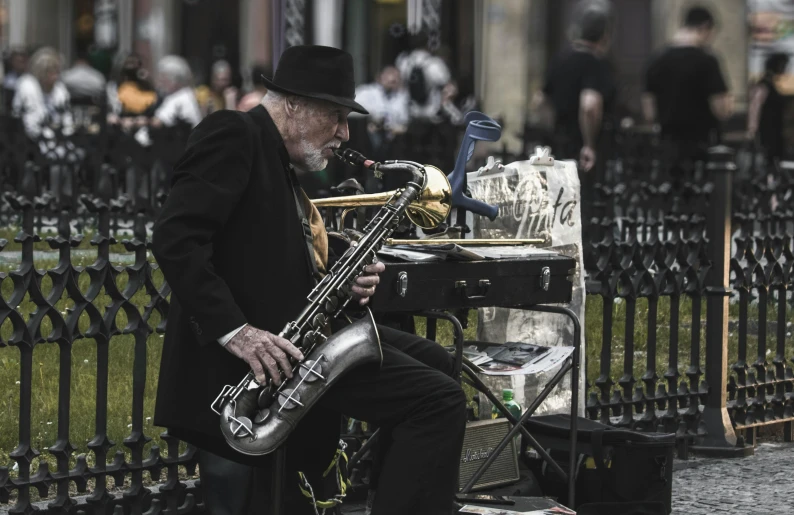 a man sitting on a bench playing a saxophone, pexels contest winner, fantastic realism, walk in a funeral procession, old man doing with mask, 🚿🗝📝, gold and black metal