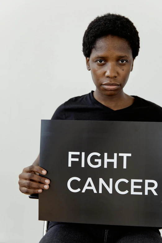 a woman holding a sign that says fight cancer, pexels contest winner, renaissance, dark complexion, press shot, profile image, people fighting