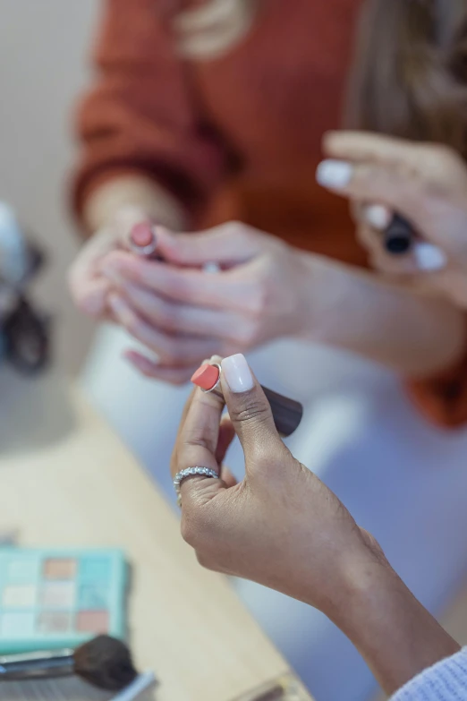 a couple of women sitting at a table with cell phones, pexels contest winner, aestheticism, nail polish, candy treatments, coloured in teal and orange, blurred detail