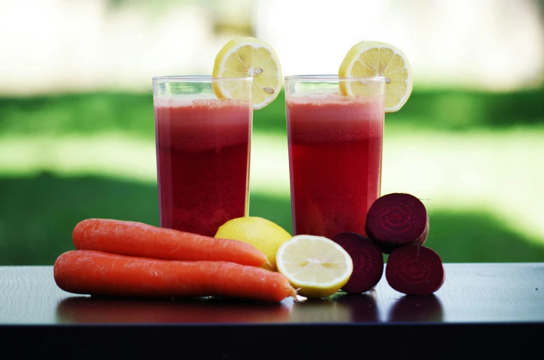 a couple of glasses of juice sitting on top of a table