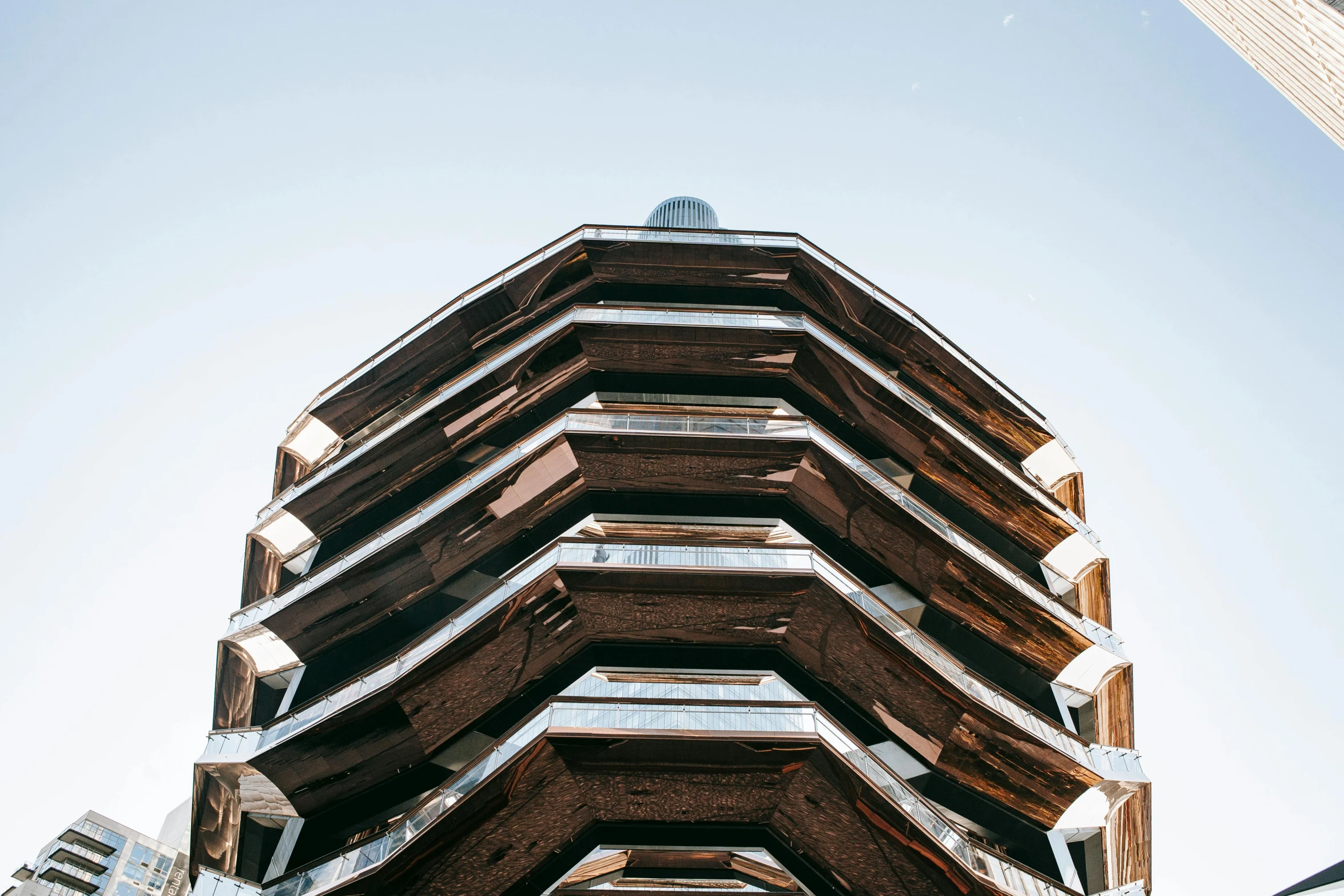 a tall building sitting in the middle of a city, an album cover, unsplash, brutalism, hexagonal shaped, intricate metal, peaked wooden roofs, new york buildings