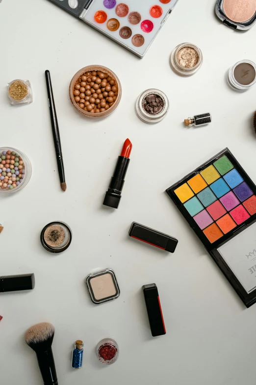 a table topped with lots of different types of makeup, a cartoon, trending on pexels, color field, thumbnail, products shot, white wall coloured workshop, cinematic image