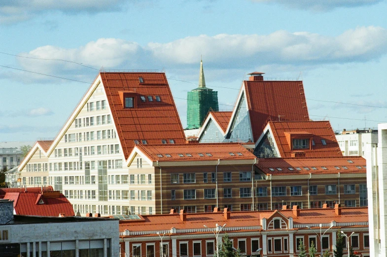 a large building with a clock on top of it, pexels contest winner, danube school, alvar aalto, tiled roofs, saint petersburg, 2 0 0 0's photo