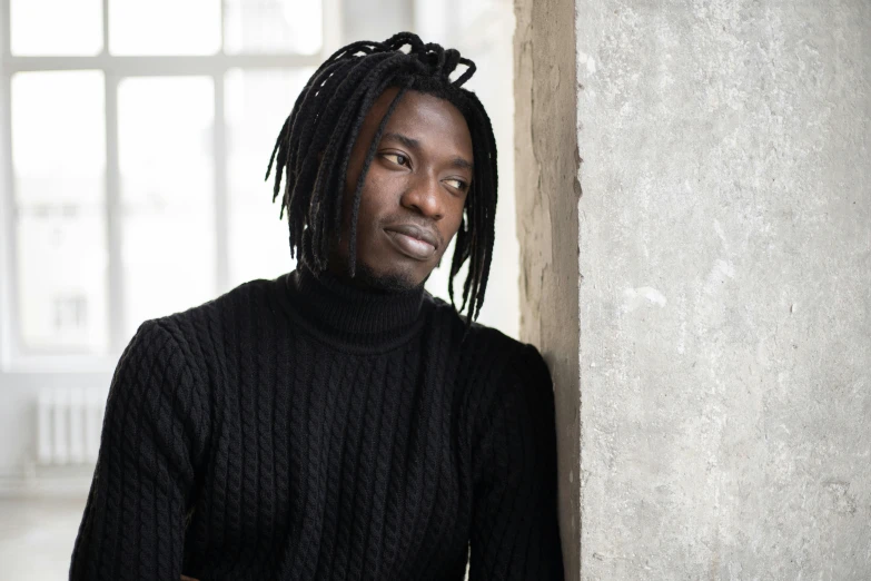 a man with dreadlocks leaning against a wall, visual art, black turtle neck shirt, dark complexion, portrait image, thoughtful )