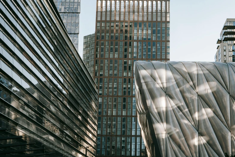 a couple of buildings that are next to each other, inspired by Zaha Hadid, unsplash contest winner, grimshaw, metallic architecture, looking towards the camera, arper's bazaar