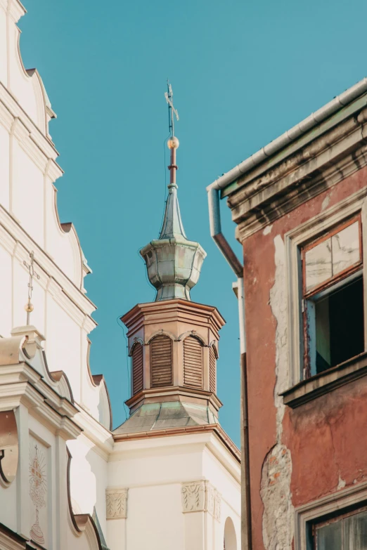 a clock that is on the side of a building, a photo, by Adam Marczyński, trending on unsplash, baroque, neoclassical tower with dome, hiding in the rooftops, color image, square