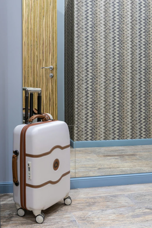 a white suitcase sitting on top of a hard wood floor, geometric wallpaper, tweed colour scheme, door, high-body detail