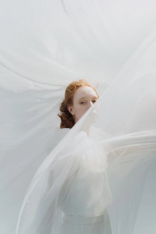 a woman with a veil over her head, an album cover, inspired by Anna Füssli, unsplash contest winner, renaissance, young redhead girl in motion, white gossamer wings, ignant, wearing a wedding dress