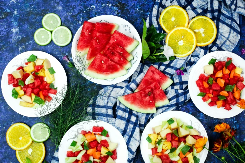 a table topped with white plates filled with slices of watermelon, by Julia Pishtar, red and teal and yellow, flatlay, blue and green and red tones, listing image