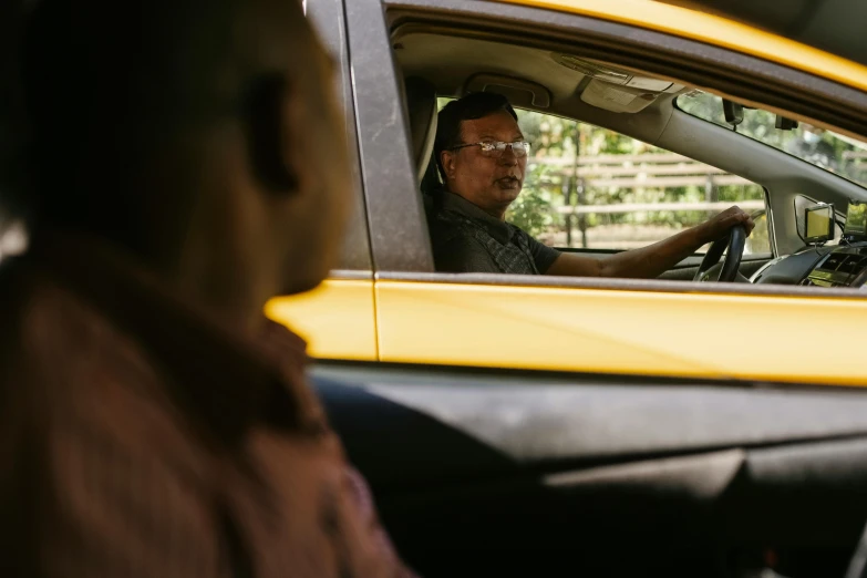 a man sitting in the driver's seat of a yellow car, pexels contest winner, happening, jakarta, avatar image, square, taxi