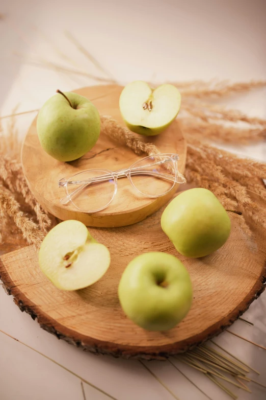 a wooden cutting board topped with green apples, renaissance, wearing small round glasses, 6 pack, golden apple, natural beauty