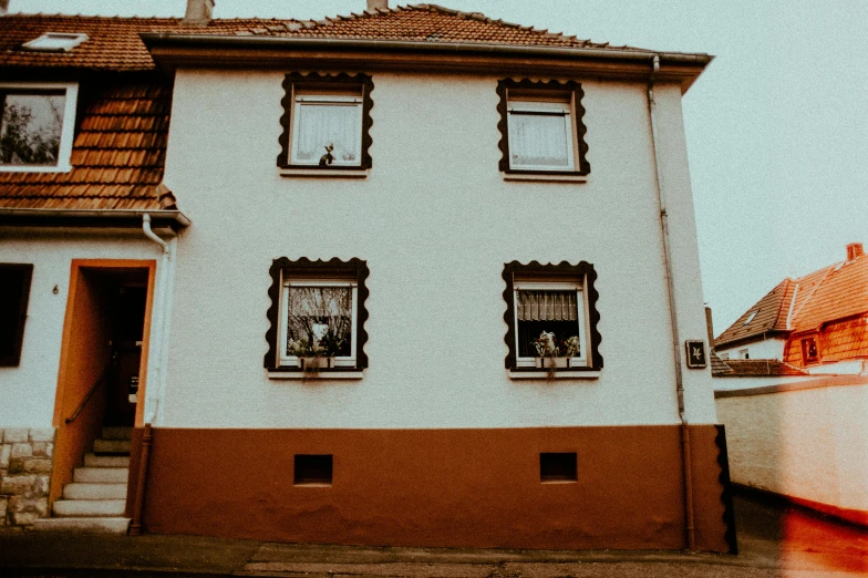 a house with a boat in front of it, by Kristian Zahrtmann, pexels contest winner, art nouveau, little windows, brown and white color scheme, photos of family on wall, 1940s photo