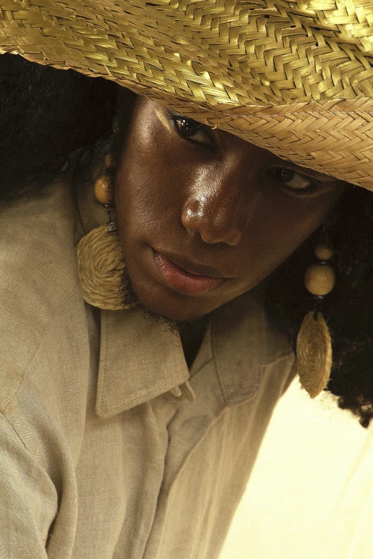 a close up of a person wearing a straw hat, afrofuturism, androgynous person, dark complexion, nilah, multiple stories