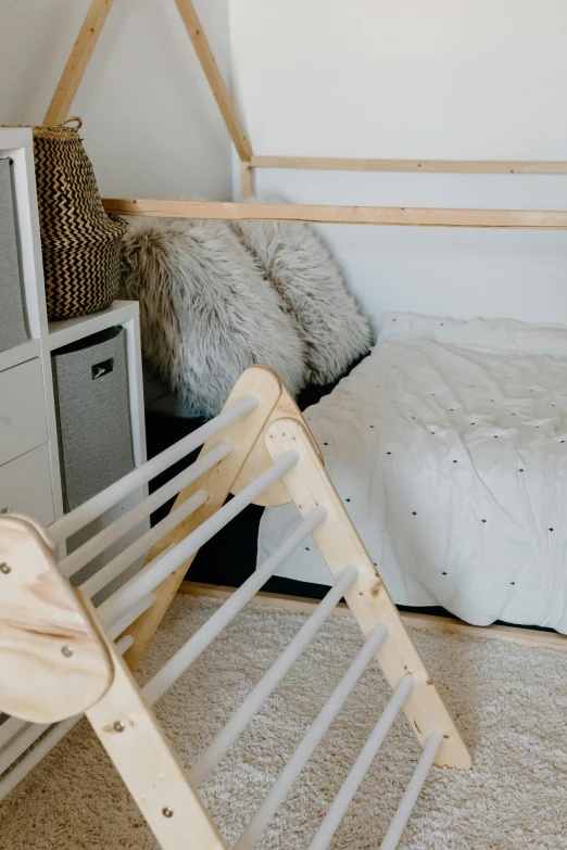 a bed room with a neatly made bed and a television, inspired by karlkka, unsplash, activity play centre, ladders, - 9, manuka