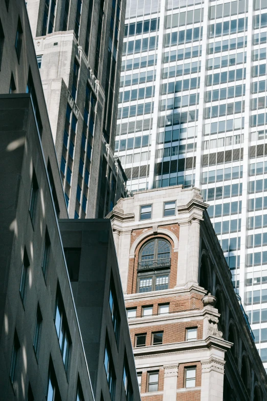 a clock that is on the side of a building, inspired by Emanuel Witz, trending on unsplash, kaiju towering above new york, 1910s architecture, high - angle view, high light on the left