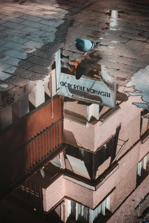 a reflection of a building in a puddle of water, an album cover, by Adam Marczyński, unsplash contest winner, graffiti, soviet apartment, bird\'s eye view, old signs, firing it into a building