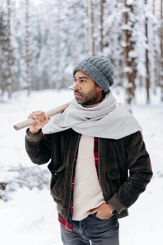 a man standing in the snow holding a baseball bat, inspired by Harrington Mann, trending on pexels, donald glover, white scarf, tourist, woods