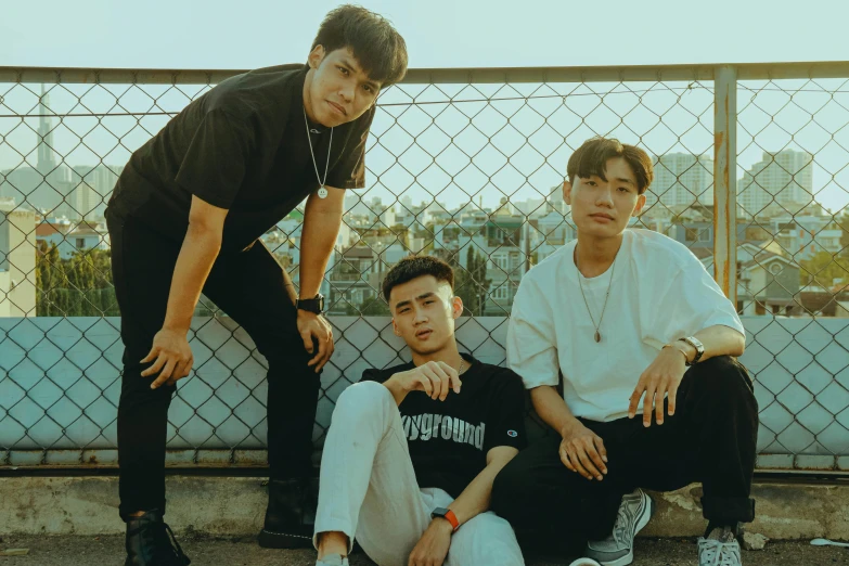 a group of young men sitting next to each other, an album cover, inspired by Gang Hui-an, pexels contest winner, lyco art, trio, confident pose, profile image, soey milk