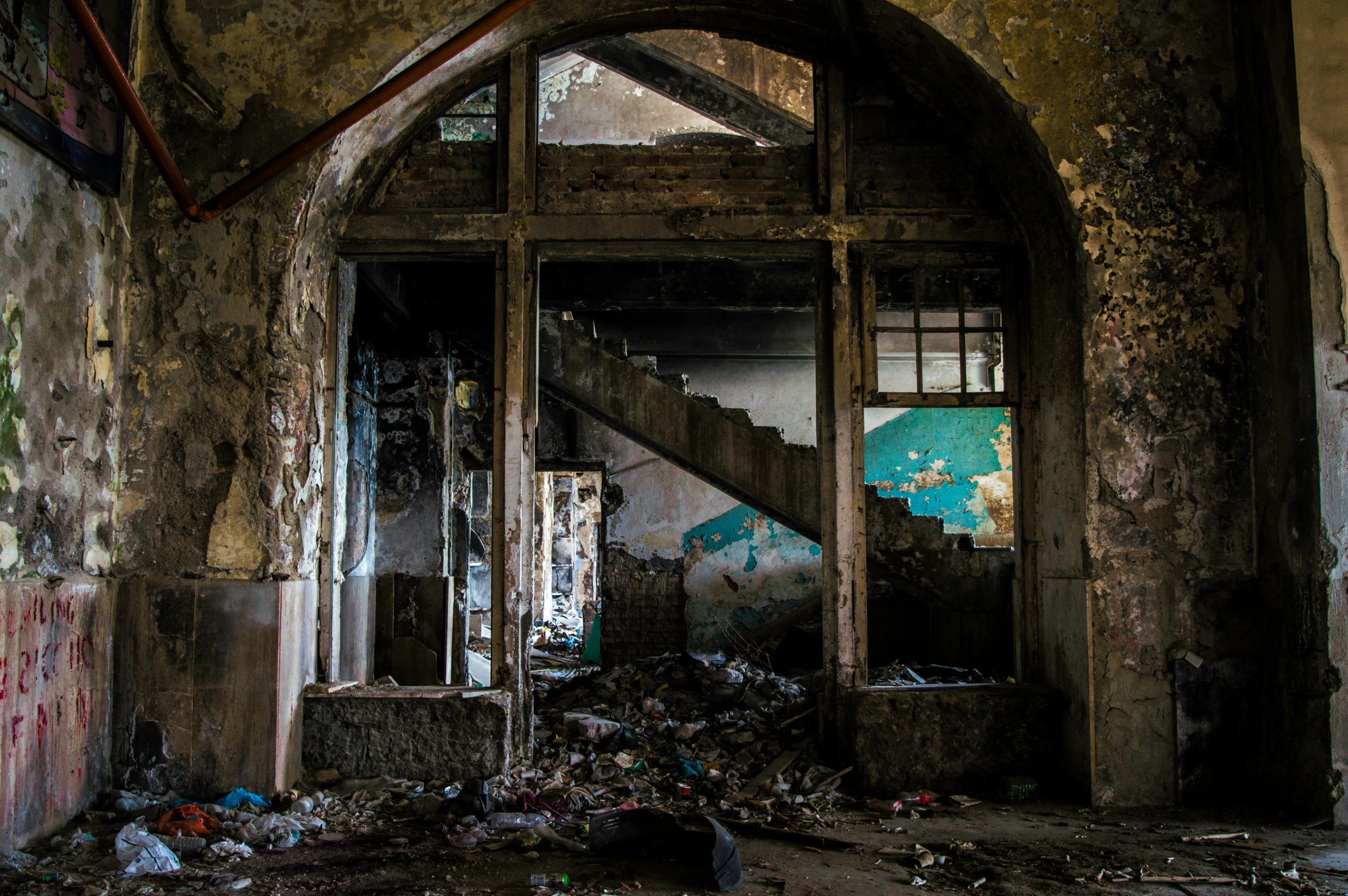 a room that has a bunch of trash on the floor, an album cover, inspired by Elsa Bleda, pexels contest winner, renaissance, stairs and arches, abandoned asylum, promo image