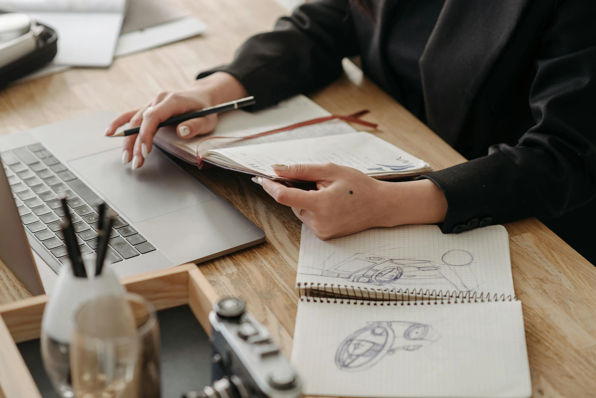 a woman sitting at a desk working on a laptop, a drawing, by Carey Morris, trending on pexels, sustainable materials, pen and paper, elegantly dressed, mechanics