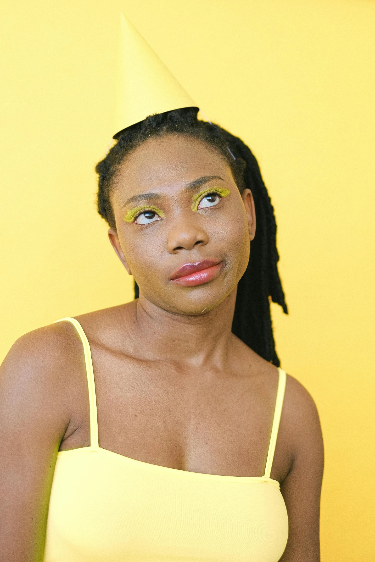a woman with a party hat on her head, an album cover, by Dulah Marie Evans, trending on pexels, visual art, wearing yellow croptop, lovingly looking at camera, nonbinary model, kano)